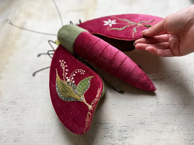 Year of the Dragon moth in Chinese Red, embroidered by Larysa Bernhardt